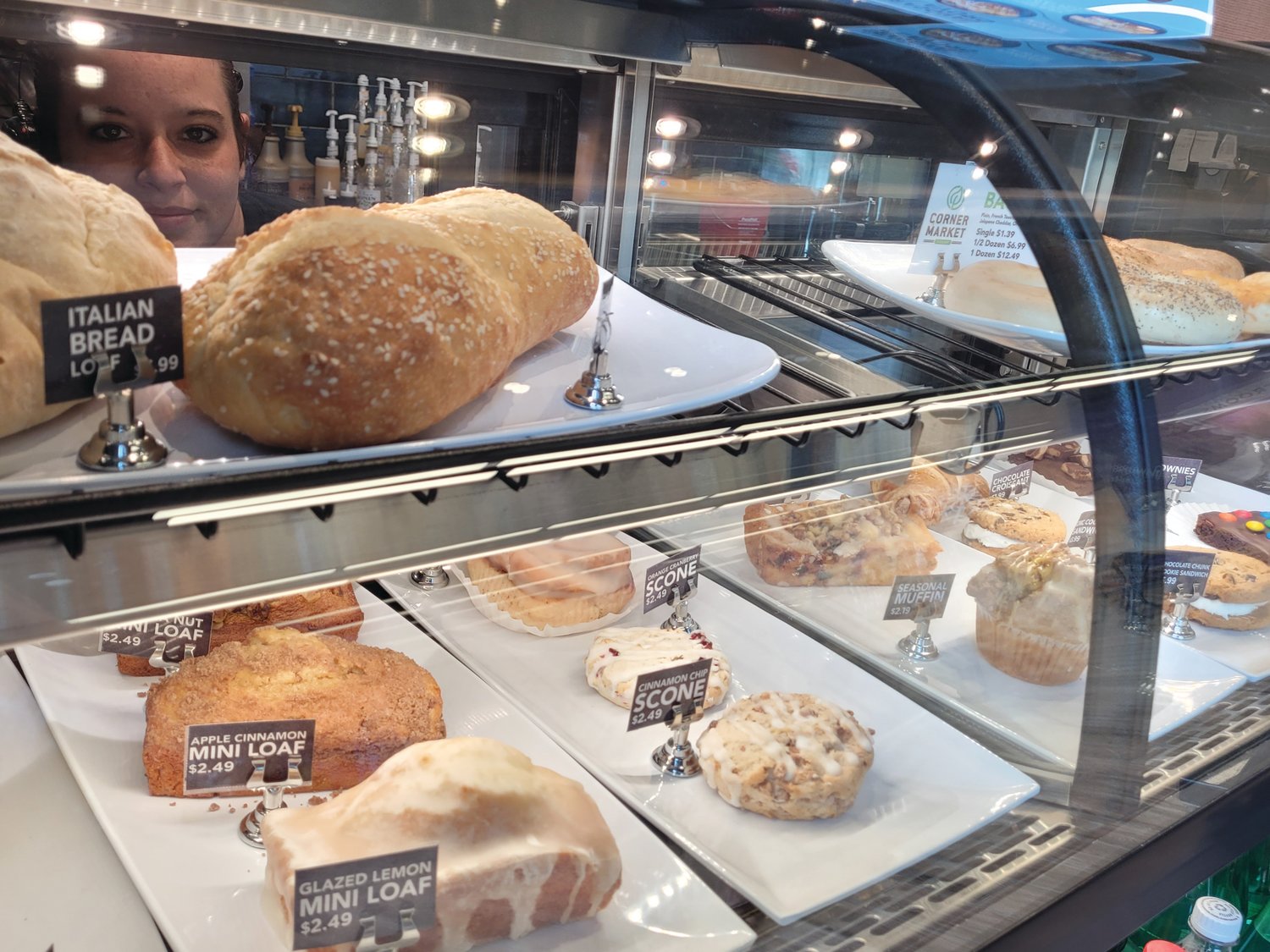 BAKED GOOD: Danni Grist, baker and barista at Seasons Corner Market in Scituate, peers through the display case.